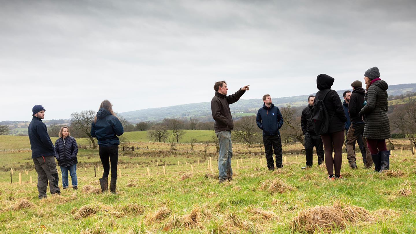 Group of volunteers standing in field.